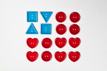 American flag made out of craft buttons in red, white and blue. White copyspace background. Simple and clean