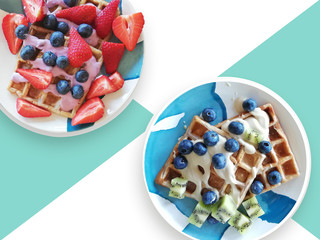 Breakfast with traditional belgian waffles with bilberry, strawberry, kiwi and yogurt. Flat lay, top view, copy space. Health vegetarian food concept