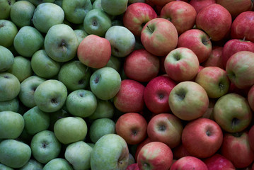 Green apples and red apples close-up. Fruit food background, close-up