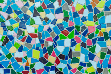Fototapeta na wymiar Colorful pastel vivid colour and various geometric shape and size of mosaic tile with random pattern.