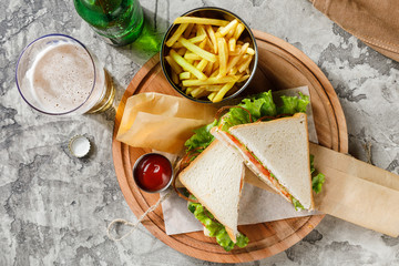 sandwich with vegetables and ham and French fries 