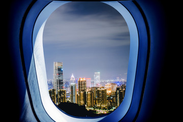 Fototapeta na wymiar Beautiful scenic night city view through the aircraft window.