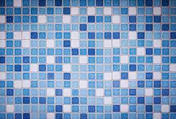 Background and texture of Mosaic tiles in blue, azure and white on decorative wall .