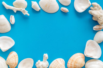 Shells frame for beach pattern on blue background top view space for text
