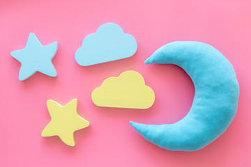Sleep time concept with moon, stars on pink background top view