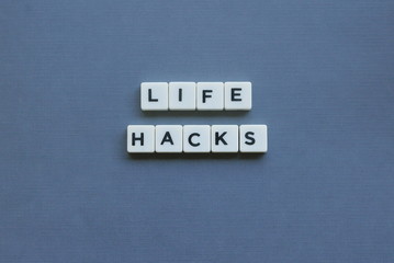 ' Life Hacks ' word made of square letter word on grey background.