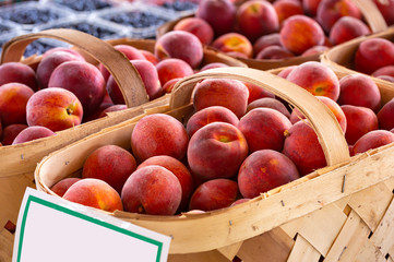 Baskets of fresh yellow peaches