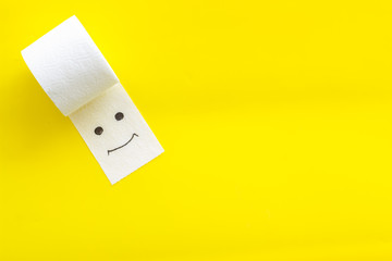 Toilet paper roll on yellow background top view copy space
