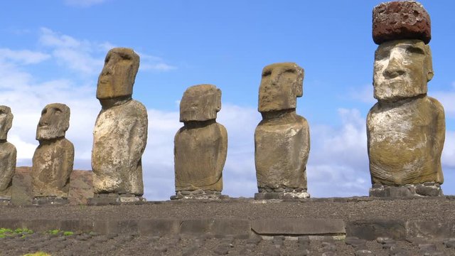 CLOSE UP: Spectacular moai statues on a remote volcanic island tower into the sunny summer sky. Breathtaking volcanic sculptures called moais remain untouched after centuries on remote Easter Island.