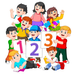 the children are holding the book and the number board