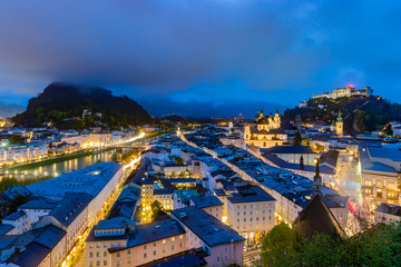 Fototapeta premium Beautiful view of Salzburg skyline with Festung Hohensalzburg and Salzach river at blue hour, Salzburger Land, Austria