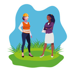 female builder and afro engineer woman on the lawn