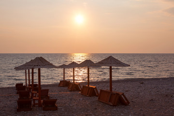 chaise lounges and umbrellas on the tropical beach 