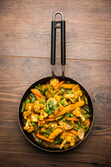 Mix vegetable curry - Indian main course recipe contains Carrots, cauliflower, green peas and beans, baby corn, capsicum and paneer/cottage cheese with traditional masala and curry, selective focus