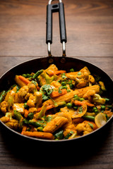 Mix vegetable curry - Indian main course recipe contains Carrots, cauliflower, green peas and beans, baby corn, capsicum and paneer/cottage cheese with traditional masala and curry, selective focus