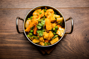 Mix vegetable curry - Indian main course recipe contains Carrots, cauliflower, green peas and beans, baby corn, capsicum and paneer/cottage cheese with traditional masala and curry, selective focus