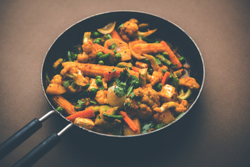 Mix vegetable curry - Indian main course recipe contains Carrots, cauliflower, green peas and beans, baby corn, capsicum and paneer/cottage cheese with traditional masala and curry, selective focus