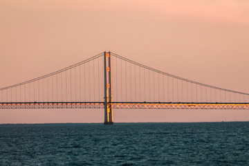 Close up of one of the towers of the Mackinac suspension bridge at sunset