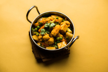 Mix vegetable curry - Indian main course recipe contains Carrots, cauliflower, green peas and beans, baby corn, capsicum and paneer/cottage cheese with traditional masala and curry, selective focus