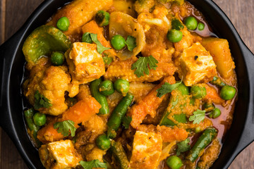 Mix vegetable curry - Indian main course recipe contains Carrots, cauliflower, green peas and beans, baby corn, capsicum and paneer/cottage cheese with traditional masala and curry, selective focus