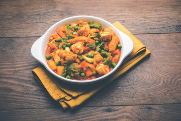 Mix vegetable curry - Indian main course recipe contains Carrots, cauliflower, green peas and beans, baby corn, capsicum and paneer/cottage cheese with traditional masala and curry, selective focus