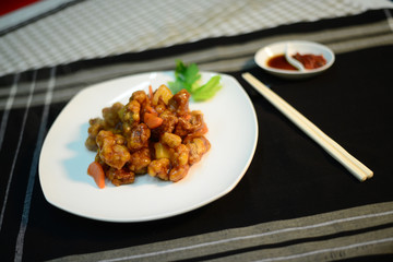 Sweet and sour pork, setup nicely on a table ready to serve