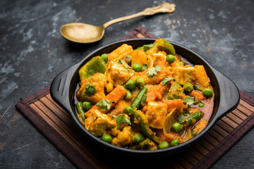 Mix vegetable curry - Indian main course recipe contains Carrots, cauliflower, green peas and beans, baby corn, capsicum and paneer/cottage cheese with traditional masala and curry, selective focus