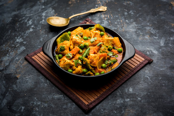 Mix vegetable curry - Indian main course recipe contains Carrots, cauliflower, green peas and beans, baby corn, capsicum and paneer/cottage cheese with traditional masala and curry, selective focus