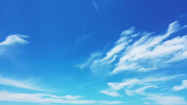 panning right shot of bright blue sky with white clouds above tropical ocean Cirrostratus