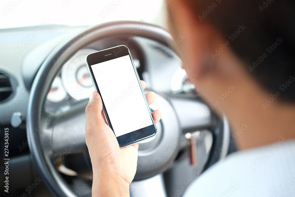 Poster cropped shot view the driver uses the phone while driving. modern smart phone with round edges. isol