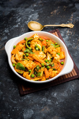 Mix vegetable curry - Indian main course recipe contains Carrots, cauliflower, green peas and beans, baby corn, capsicum and paneer/cottage cheese with traditional masala and curry, selective focus