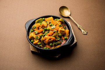 Mix vegetable curry - Indian main course recipe contains Carrots, cauliflower, green peas and beans, baby corn, capsicum and paneer/cottage cheese with traditional masala and curry, selective focus