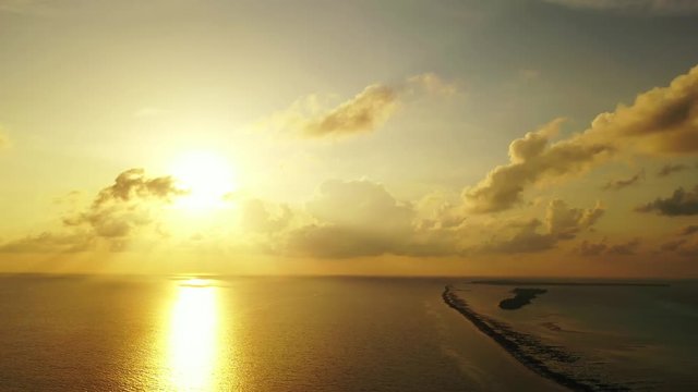 golden sunset over Barbados coral reefs, dramatic sky over Atlantic ocean, dramatic sky with fluffy clouds