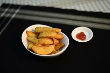 Crispy potato wedges, setup nicely on table ready to serve