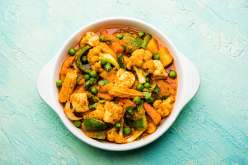 Mix vegetable curry - Indian main course recipe contains Carrots, cauliflower, green peas and beans, baby corn, capsicum and paneer/cottage cheese with traditional masala and curry, selective focus
