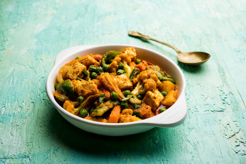 Mix vegetable curry - Indian main course recipe contains Carrots, cauliflower, green peas and beans, baby corn, capsicum and paneer/cottage cheese with traditional masala and curry, selective focus