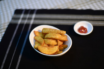 Crispy potato wedges, setup nicely on table ready to serve