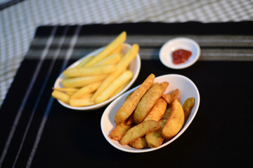 Crispy potato chips and wedges, setup nicely on table ready to serve