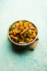 Mix vegetable curry - Indian main course recipe contains Carrots, cauliflower, green peas and beans, baby corn, capsicum and paneer/cottage cheese with traditional masala and curry, selective focus