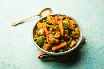 Mix vegetable curry - Indian main course recipe contains Carrots, cauliflower, green peas and beans, baby corn, capsicum and paneer/cottage cheese with traditional masala and curry, selective focus