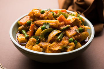 Mix vegetable curry - Indian main course recipe contains Carrots, cauliflower, green peas and beans, baby corn, capsicum and paneer/cottage cheese with traditional masala and curry, selective focus