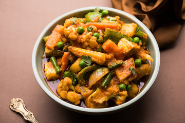 Mix vegetable curry - Indian main course recipe contains Carrots, cauliflower, green peas and beans, baby corn, capsicum and paneer/cottage cheese with traditional masala and curry, selective focus