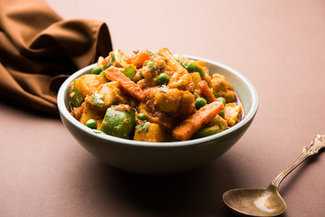 Mix vegetable curry - Indian main course recipe contains Carrots, cauliflower, green peas and beans, baby corn, capsicum and paneer/cottage cheese with traditional masala and curry, selective focus