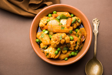 Mix vegetable curry - Indian main course recipe contains Carrots, cauliflower, green peas and beans, baby corn, capsicum and paneer/cottage cheese with traditional masala and curry, selective focus