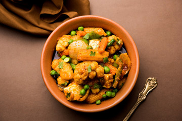 Mix vegetable curry - Indian main course recipe contains Carrots, cauliflower, green peas and beans, baby corn, capsicum and paneer/cottage cheese with traditional masala and curry, selective focus