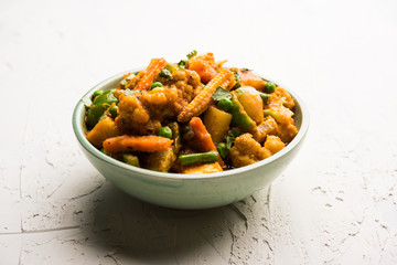 Mix vegetable curry - Indian main course recipe contains Carrots, cauliflower, green peas and beans, baby corn, capsicum and paneer/cottage cheese with traditional masala and curry, selective focus