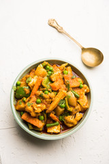 Mix vegetable curry - Indian main course recipe contains Carrots, cauliflower, green peas and beans, baby corn, capsicum and paneer/cottage cheese with traditional masala and curry, selective focus