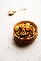 Mix vegetable curry - Indian main course recipe contains Carrots, cauliflower, green peas and beans, baby corn, capsicum and paneer/cottage cheese with traditional masala and curry, selective focus