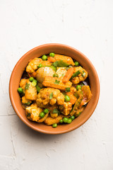 Mix vegetable curry - Indian main course recipe contains Carrots, cauliflower, green peas and beans, baby corn, capsicum and paneer/cottage cheese with traditional masala and curry, selective focus