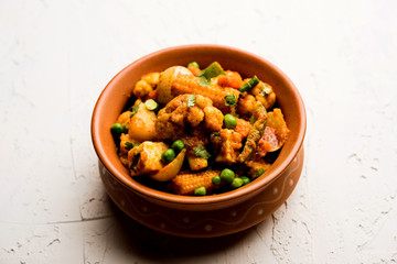 Mix vegetable curry - Indian main course recipe contains Carrots, cauliflower, green peas and beans, baby corn, capsicum and paneer/cottage cheese with traditional masala and curry, selective focus
